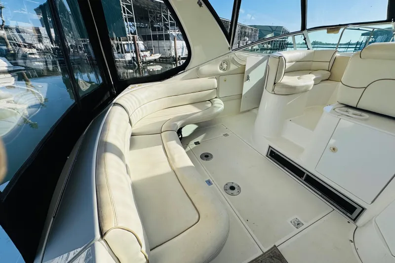 Slide: The Image of Interior of 2000 Cruisers Yachts 3575 Express with white seating and marina view. - 22