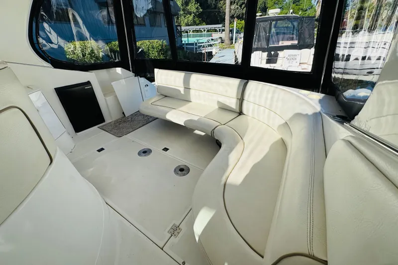 Slide: The Image of Spacious interior of 2000 Cruisers Yachts 3575 Express with curved seating and large windows. - 23
