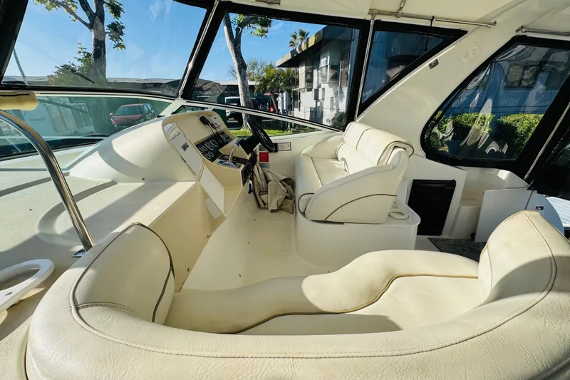 Slide: The Image of Interior of 2000 Cruisers Yachts 3575 Express, featuring plush seating and modern helm controls. - 24