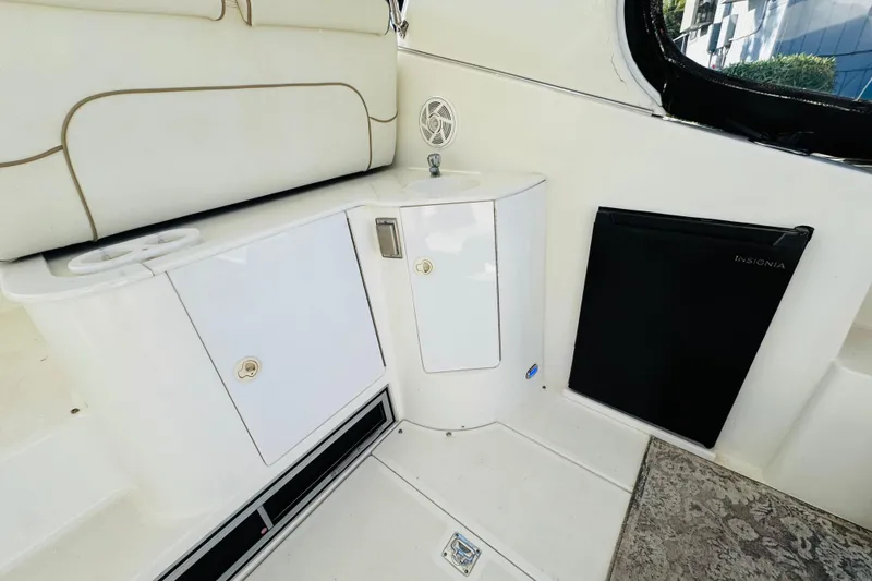 Slide: The Image of Interior of 2000 Cruisers Yachts 3575 Express with sink, storage, and mini fridge. - 26