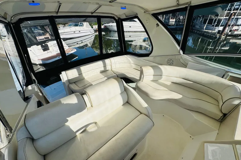 Slide: The Image of Interior of 2000 Cruisers Yachts 3575 Express with white leather seating and marina view. - 28