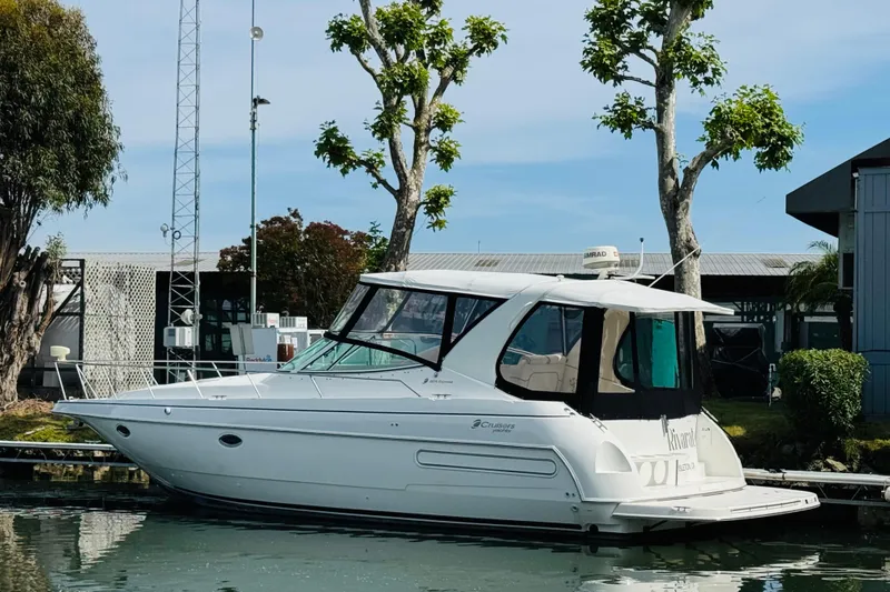 Slide: The Image of 2000 Cruisers Yachts 3575 Express docked near trees and buildings. - 3