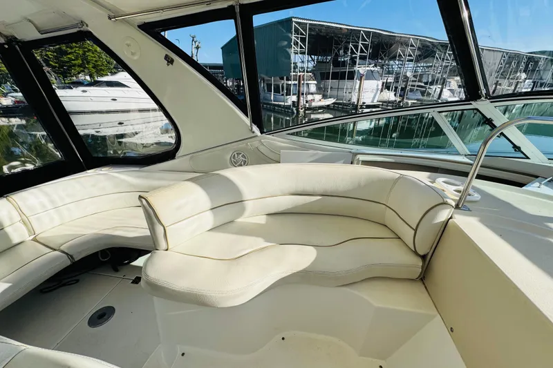 Slide: The Image of Interior view of 2000 Cruisers Yachts 3575 Express with white seating and marina backdrop. - 30