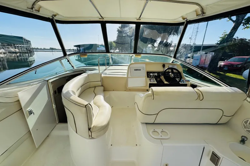 Slide: The Image of 2000 Cruisers Yachts 3575 Express cockpit with helm, seating, and marina view. - 31