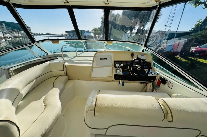 Slide: The Image of Cockpit view of 2000 Cruisers Yachts 3575 Express with leather seating and steering console. - 32