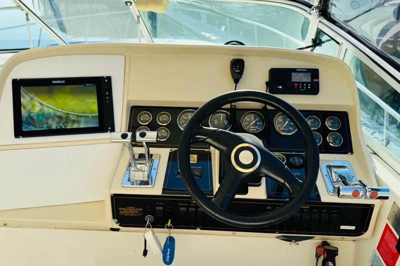 Slide: The Image of Cockpit of 2000 Cruisers Yachts 3575 Express with steering wheel and navigation instruments. - 35