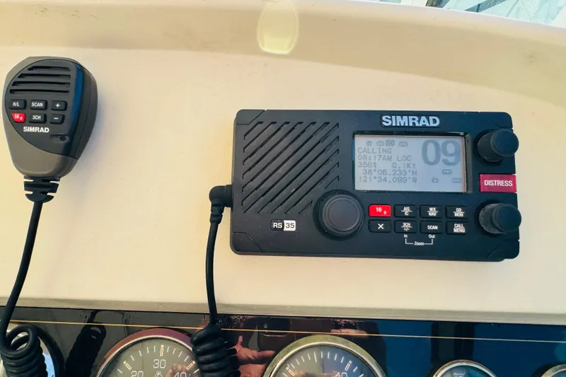 Slide: The Image of Simrad marine radio on 2000 Cruisers Yachts 3575 Express dashboard, displaying coordinates. - 41