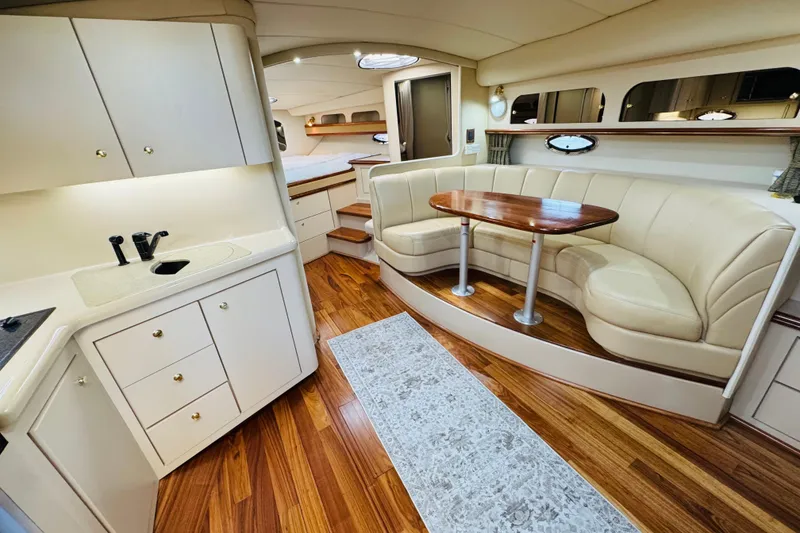 Slide: The Image of Luxurious interior of 2000 Cruisers Yachts 3575 Express with elegant seating and kitchenette. - 44