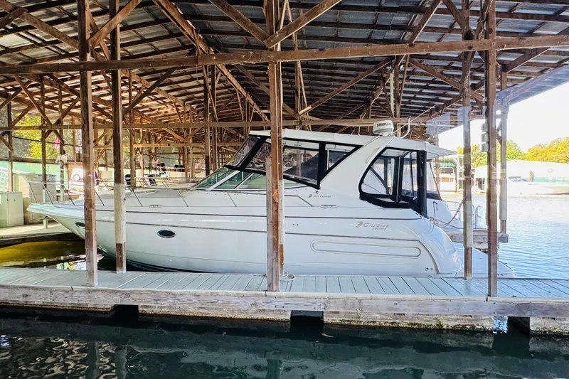 Slide: The Image of 2000 Cruisers Yachts 3575 Express docked in a covered marina. - 5