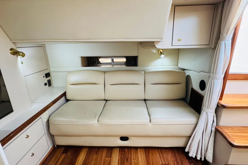 Slide: The Image of Interior of 2000 Cruisers Yachts 3575 Express with cream leather sofa and wooden flooring. - 52