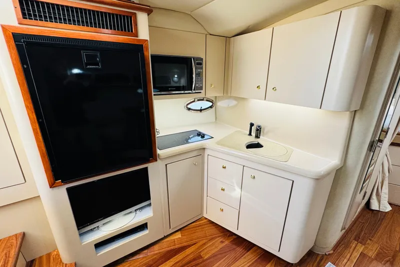 Slide: The Image of Luxurious kitchen area in 2000 Cruisers Yachts 3575 Express with modern appliances. - 53