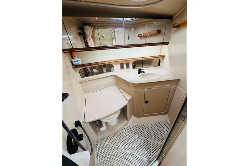 Slide: The Image of Bathroom interior of 2000 Cruisers Yachts 3575 Express, featuring sink and toilet. - 56