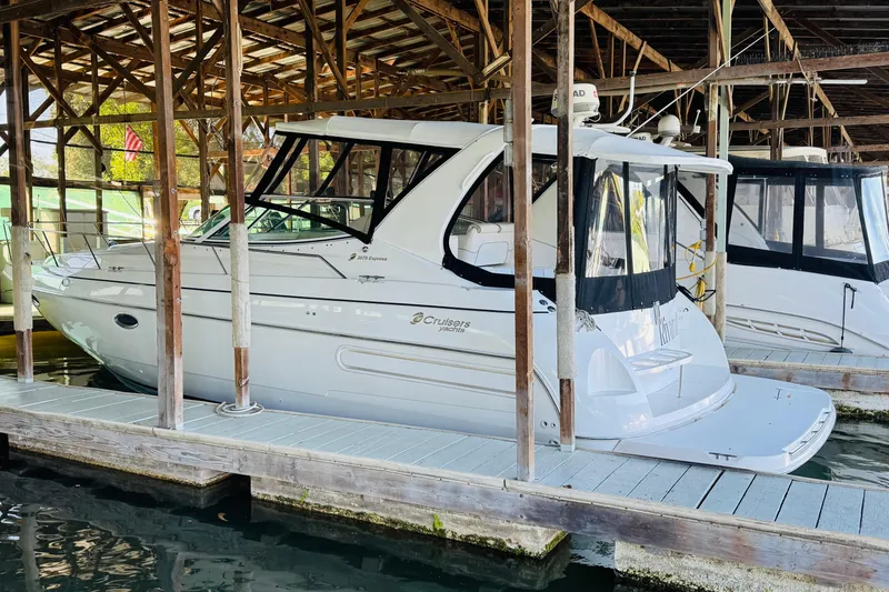 Slide: The Image of 2000 Cruisers Yachts 3575 Express docked in a covered marina. - 6