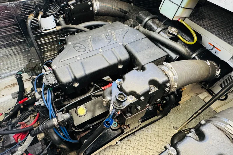 Slide: The Image of Engine compartment of a 2000 Cruisers Yachts 3575 Express, showcasing detailed components. - 62
