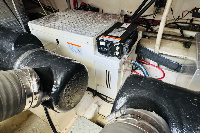 Slide: The Image of Engine room of 2000 Cruisers Yachts 3575 Express with visible generator and wiring. - 63