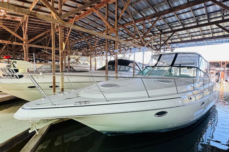Slide: The Image of 2000 Cruisers Yachts 3575 Express docked in a covered marina. - 7