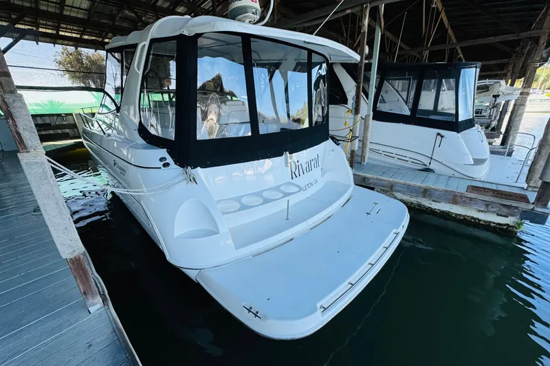 Slide: The Image of 2000 Cruisers Yachts 3575 Express docked in a covered marina. - 8