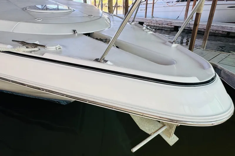 Slide: The Image of 2000 Cruisers Yachts 3575 Express boat docked, showcasing sleek bow design. - 9