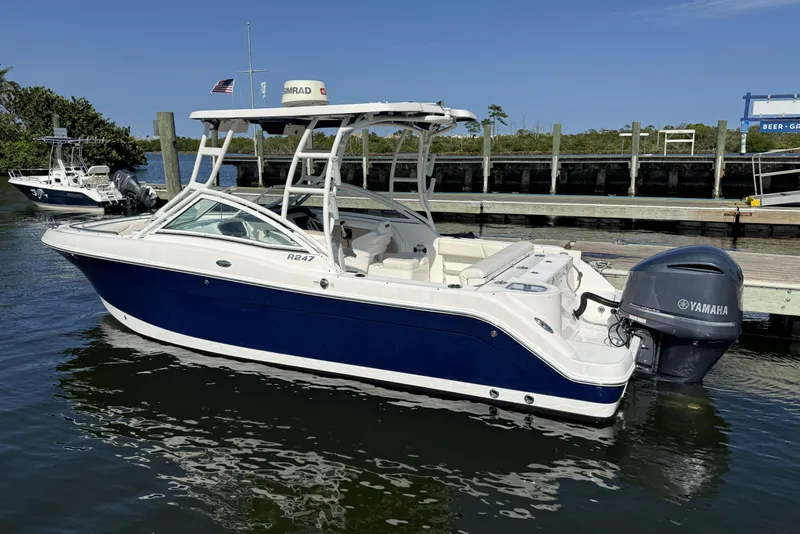 The Image of 2018 Robalo R247 Dual Console boat docked with Yamaha outboard motor. - 1