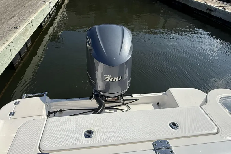 Slide: The Image of 2018 Robalo R247 Dual Console with Yamaha 300 engine at dock. - 10