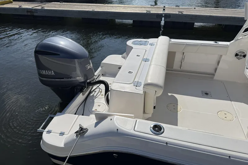 Slide: The Image of 2018 Robalo R247 Dual Console boat with Yamaha 300 engine at dock. - 11