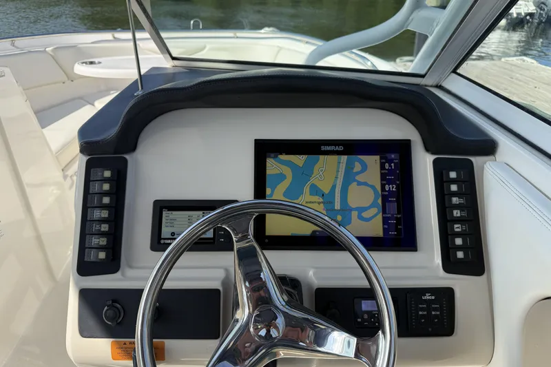 Slide: The Image of 2018 Robalo R247 Dual Console dashboard with navigation display and controls. - 5