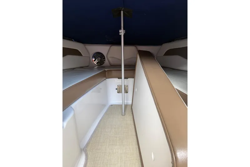 Slide: The Image of Interior of 2016 Chaparral 226 SSi Wide Tech boat with beige seating and carpet. - 10