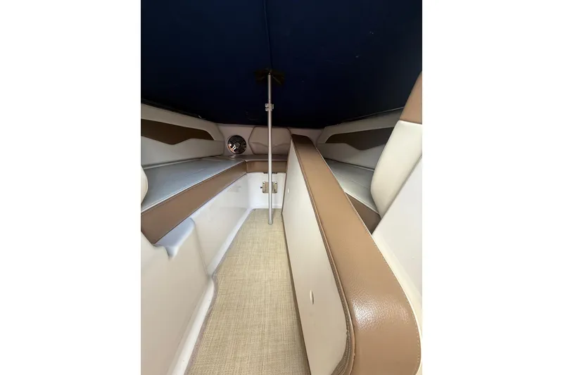 Slide: The Image of Interior of 2016 Chaparral 226 SSi Wide Tech boat, featuring beige and brown seating. - 11
