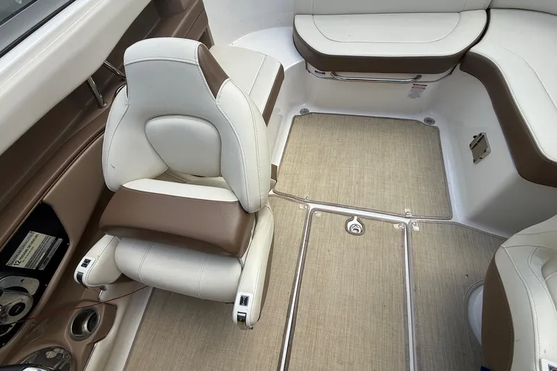 Slide: The Image of 2016 Chaparral 226 SSi Wide Tech boat interior with beige and brown seating. - 14