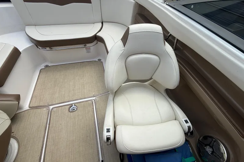 Slide: The Image of Interior of 2016 Chaparral 226 SSi Wide Tech boat with beige seating and carpet. - 16