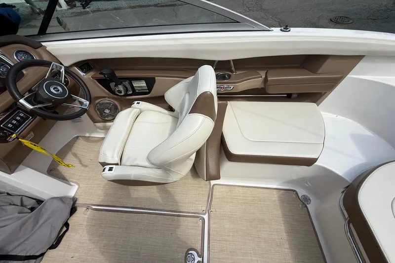 Slide: The Image of Interior of 2016 Chaparral 226 SSi Wide Tech boat with beige seating and steering wheel. - 18