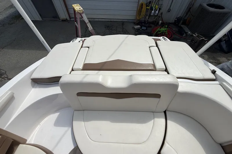 Slide: The Image of 2016 Chaparral 226 SSi Wide Tech boat interior with white and brown seating. - 21