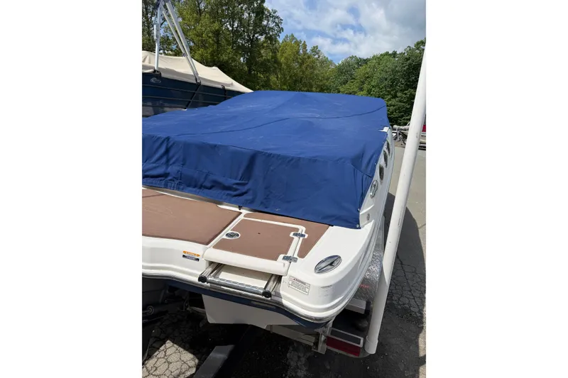 Slide: The Image of 2016 Chaparral 226 SSi Wide Tech boat with blue cover, parked outdoors. - 27