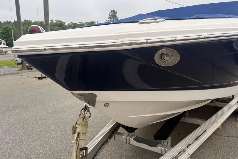 Slide: The Image of 2016 Chaparral 226 SSi Wide Tech boat on trailer, blue and white hull. - 4