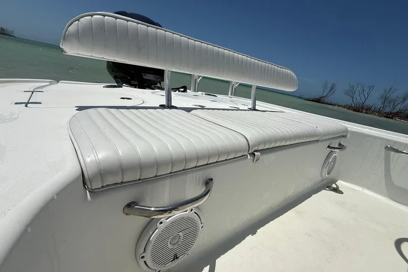 Slide: The Image of 2013 Yellowfin 21 Bay boat with white seating, ocean backdrop, and clear blue sky. - 12