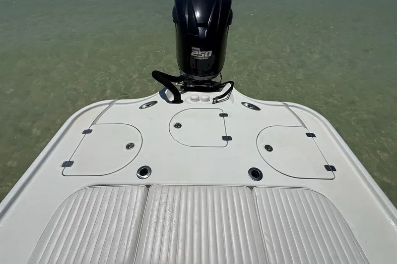 Slide: The Image of 2013 Yellowfin 21 Bay boat deck with outboard motor on clear water. - 13