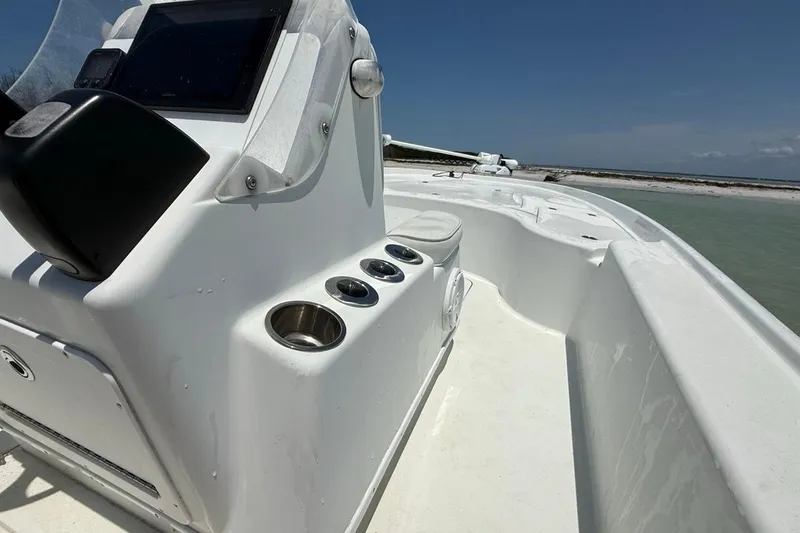 Slide: The Image of 2013 Yellowfin 21 Bay boat interior with console and cup holders. - 16