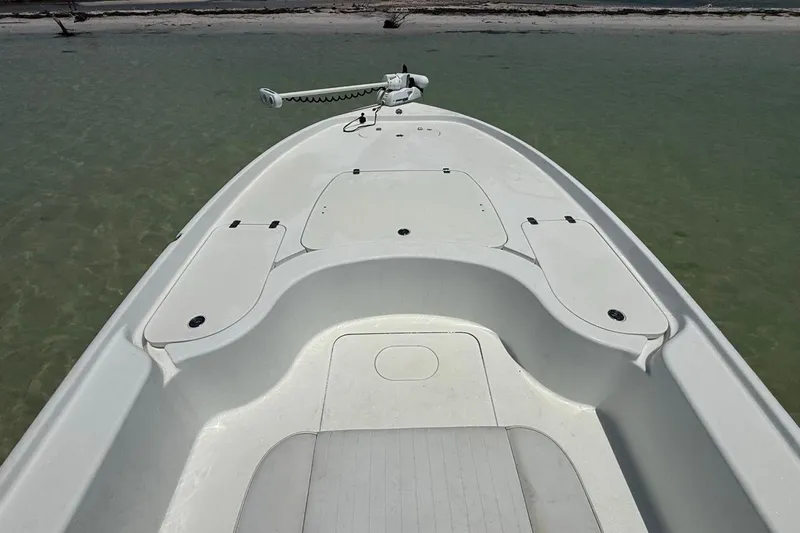 Slide: The Image of 2013 Yellowfin 21 Bay boat deck on calm water, showcasing storage compartments. - 17