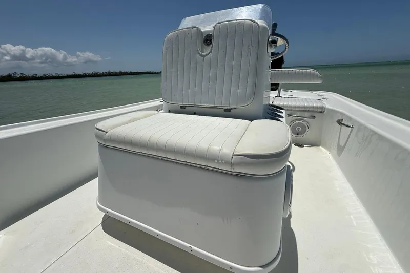 Slide: The Image of 2013 Yellowfin 21 Bay boat interior with white seating, on calm water. - 18