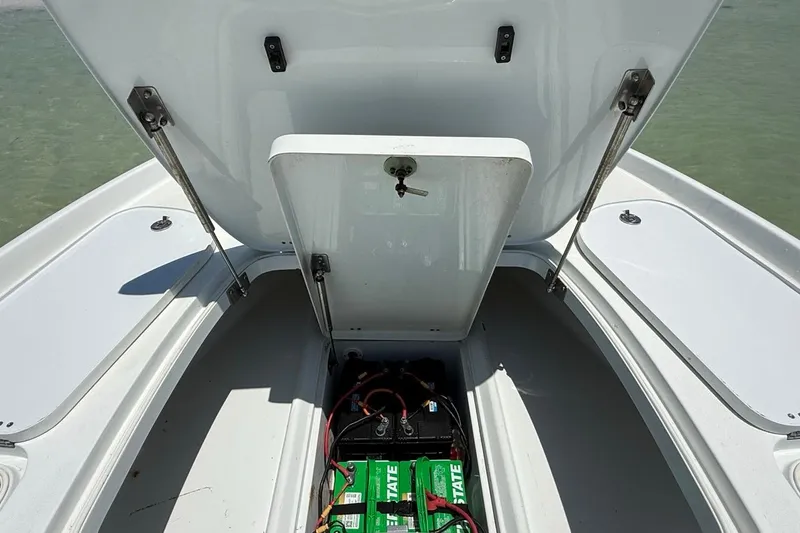 Slide: The Image of Open storage compartment of a 2013 Yellowfin 21 Bay boat, revealing batteries inside. - 20