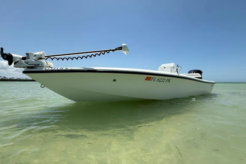 Slide: The Image of 2013 Yellowfin 21 Bay boat in shallow water under clear blue sky. - 21
