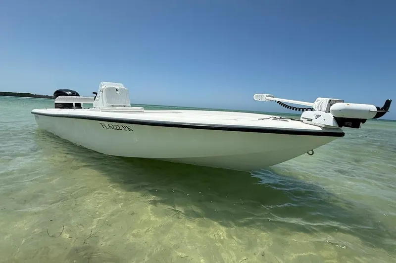 Slide: The Image of 2013 Yellowfin 21 Bay boat in shallow clear water, showcasing sleek design and outboard motor. - 5