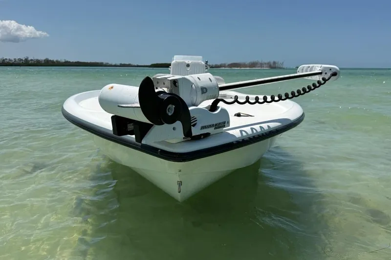 Slide: The Image of 2013 Yellowfin 21 Bay boat in shallow turquoise water, featuring a trolling motor. - 6