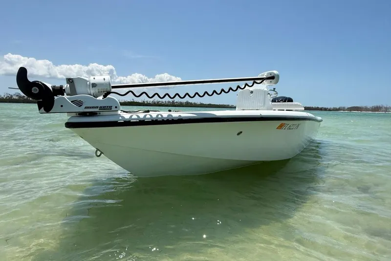 Slide: The Image of 2013 Yellowfin 21 Bay boat in shallow turquoise water, featuring a trolling motor. - 8