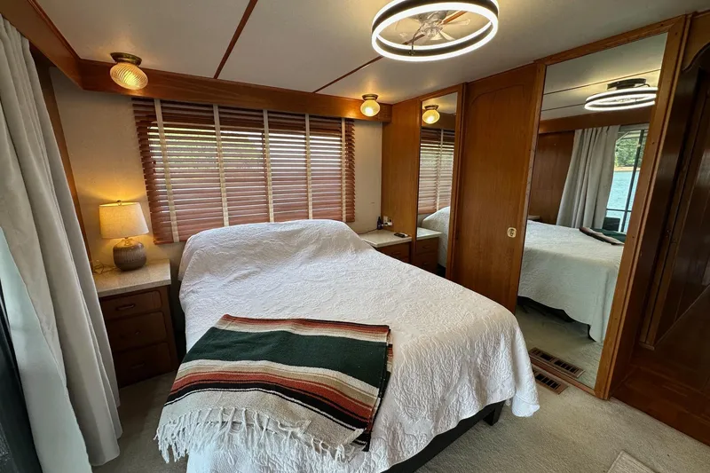 Slide: The Image of Cozy bedroom in a 1990 Lazy Days 14x72 houseboat, featuring wood accents and modern lighting. - 10
