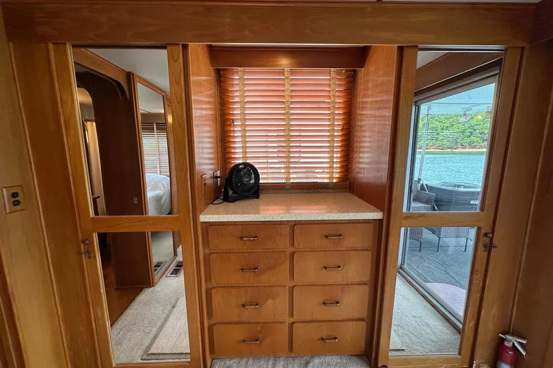Slide: The Image of Interior of 1990 Lazy Days 14x72 houseboat with wooden cabinetry and lake view. - 11