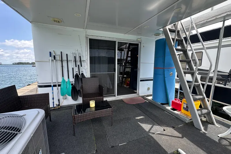 Slide: The Image of Houseboat deck with chairs, paddles, and ladder; Lazy Days 14x72, 1990 model. - 13