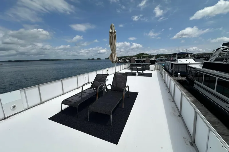 Slide: The Image of Rooftop deck of 1990 Lazy Days 14x72 houseboat with lounge chairs and umbrella. - 16