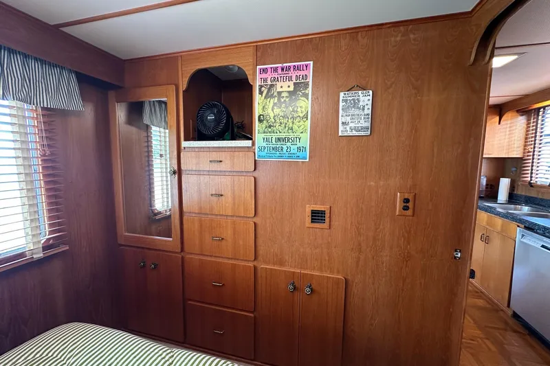 Slide: The Image of Interior of a 1990 Lazy Days 14x72 houseboat with wood paneling and vintage decor. - 7