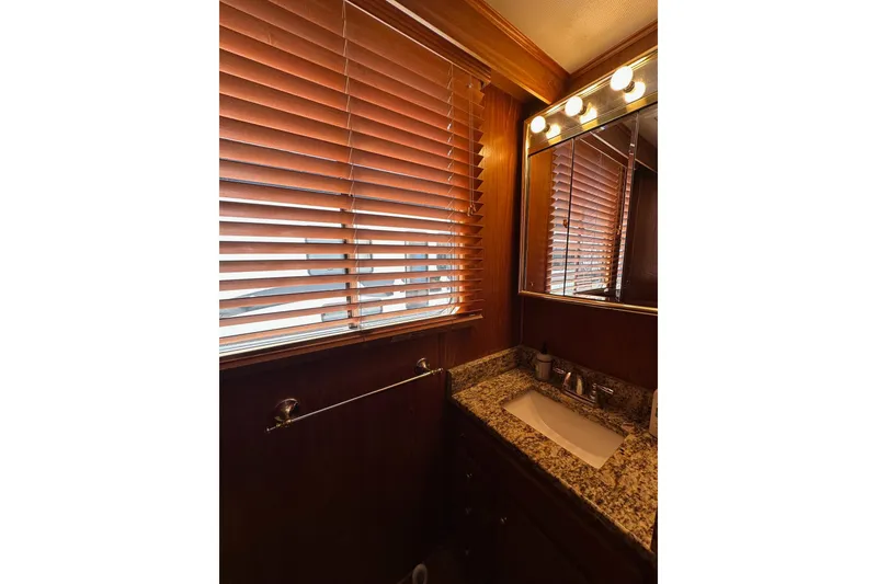 Slide: The Image of Bathroom interior of 1990 Lazy Days 14x72 with granite countertop and wooden blinds. - 8